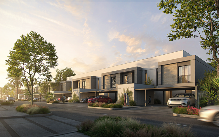 Exterior street view of Yas Acres The Orchids townhouses at dusk, showing modern two-story homes with covered carports, landscaped gardens, and mature trees along the road.