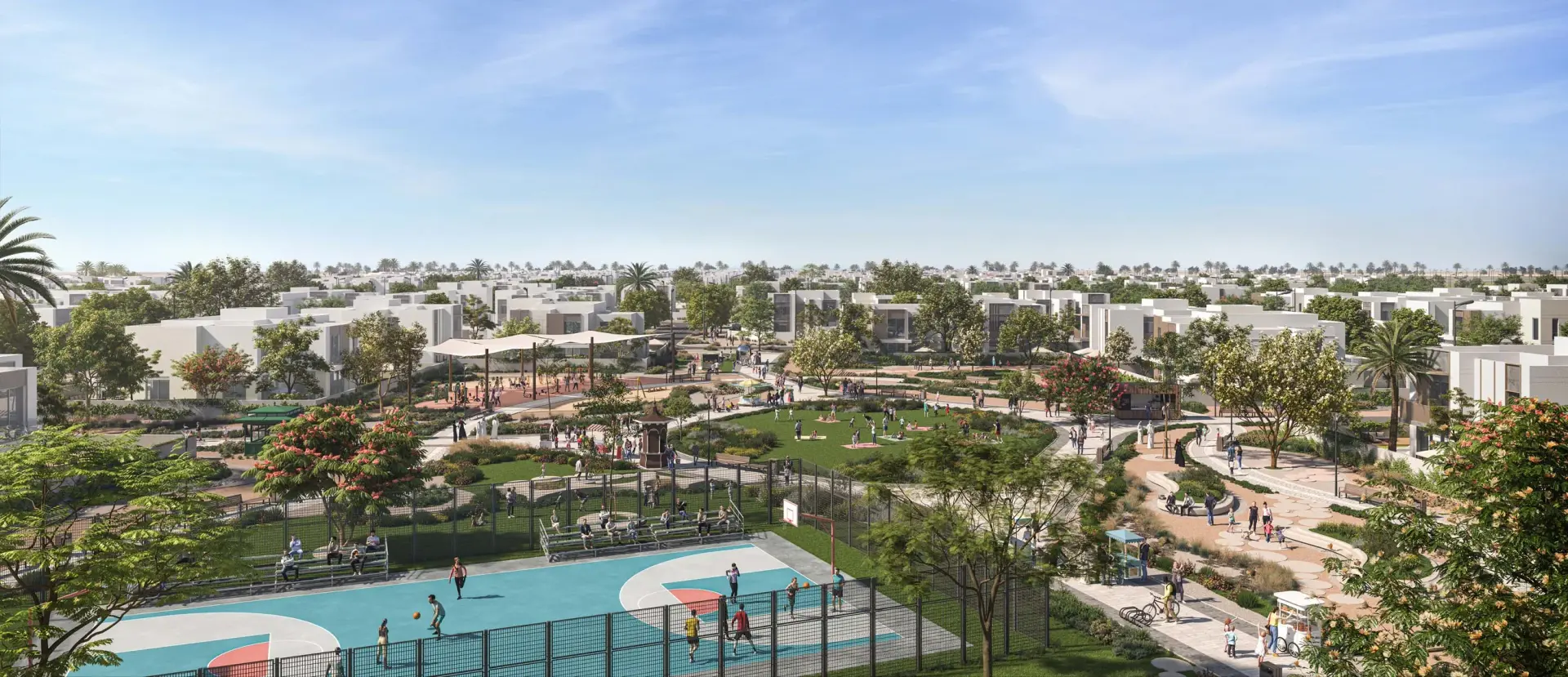 Aerial view of Fay Al Reeman II community with a basketball court, landscaped park with seating and walking paths, playground areas, and low-rise residential villas in the background.