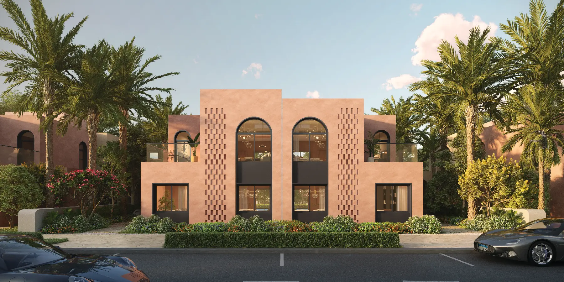 Symmetrical front elevation rendering of a modern two-story luxury duplex at Ogami, Ras El Hekma, featuring smooth terracotta-pink stucco facades, large arched glass windows with dark frames, textured brick screens, and date palm trees under a soft morning sky with a parked sports car in the foreground.