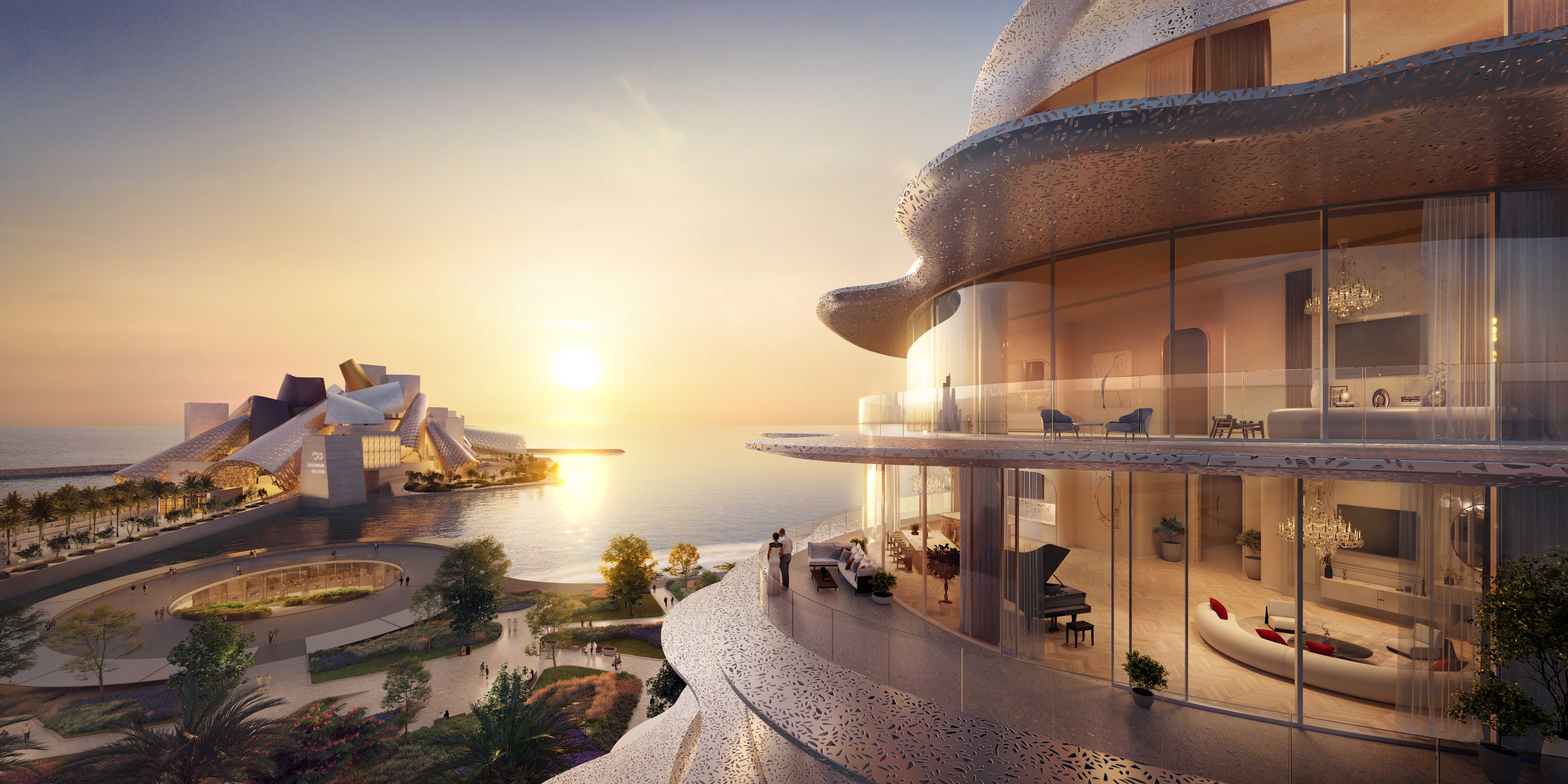 Sunset view from the balcony of a Baccarat Residences Saadiyat apartment, with a couple standing on the perforated-screen terrace overlooking the Guggenheim Abu Dhabi and the sea, and an ornately furnished interior with a chandelier and grand piano visible through the glass.
