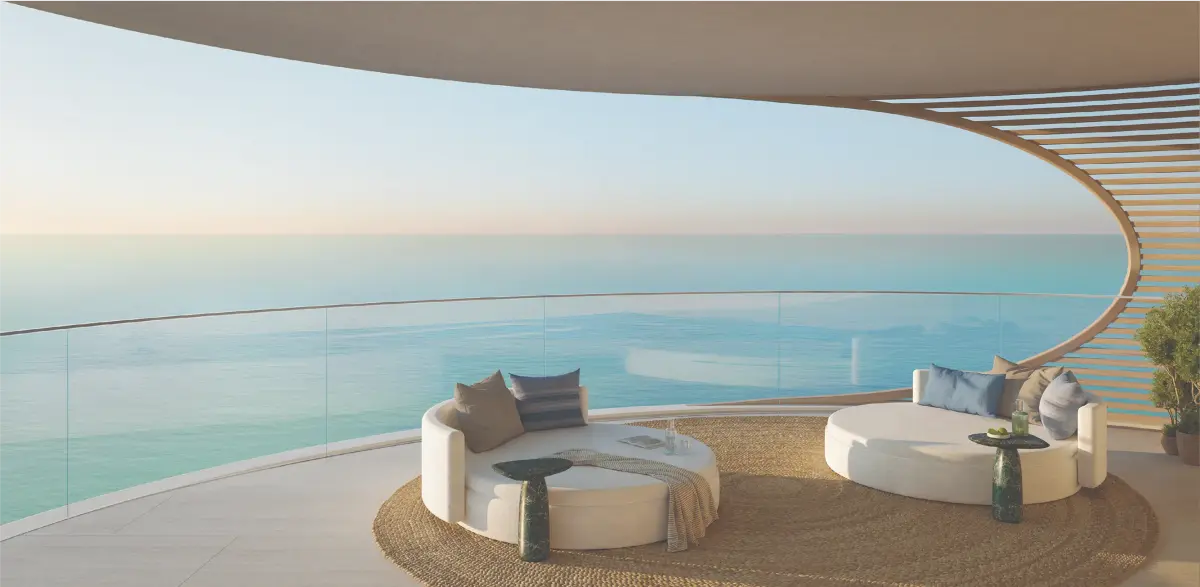 Curved balcony at Fahid Beach Terraces with timber slat screening, glass balustrade, and outdoor lounge seating overlooking an open sea view.