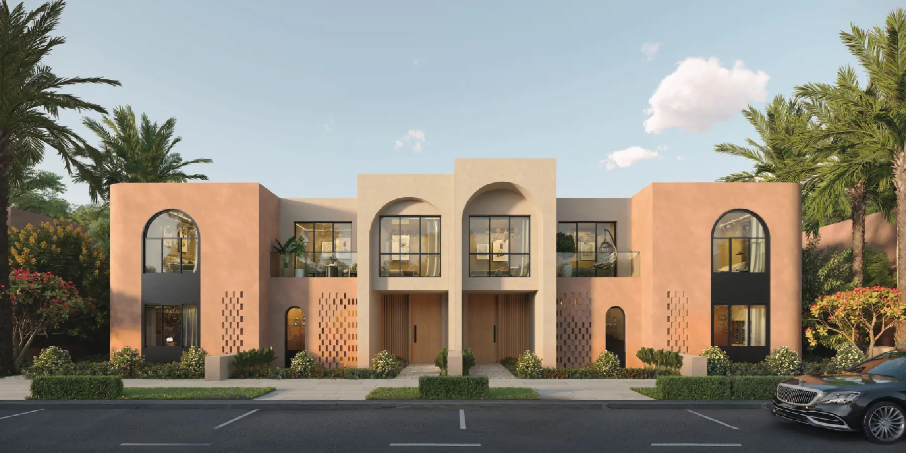 Symmetrical front elevation of a luxury two-story modern residential duplex at Ogami, Ras El Hekma, showcasing sandy-beige stucco arches, terracotta-pink side wings with arched windows, double wooden main entrance doors, hanging rattan egg swing chairs, and lush tropical landscaping.